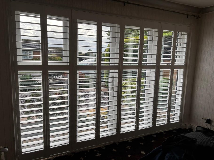 Custom plantation shutters on patio doors in High Ercall, Shropshire home | Seamless privacy & garden views by ShireLuxe Shutters Shropshire
