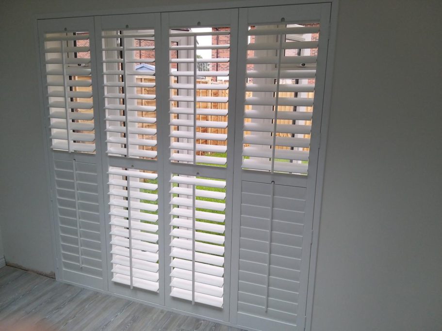 Composite faux wood shutters on patio doors in Wolverhampton home | Waterproof luxury & privacy by ShireLuxe Shutters Shropshire